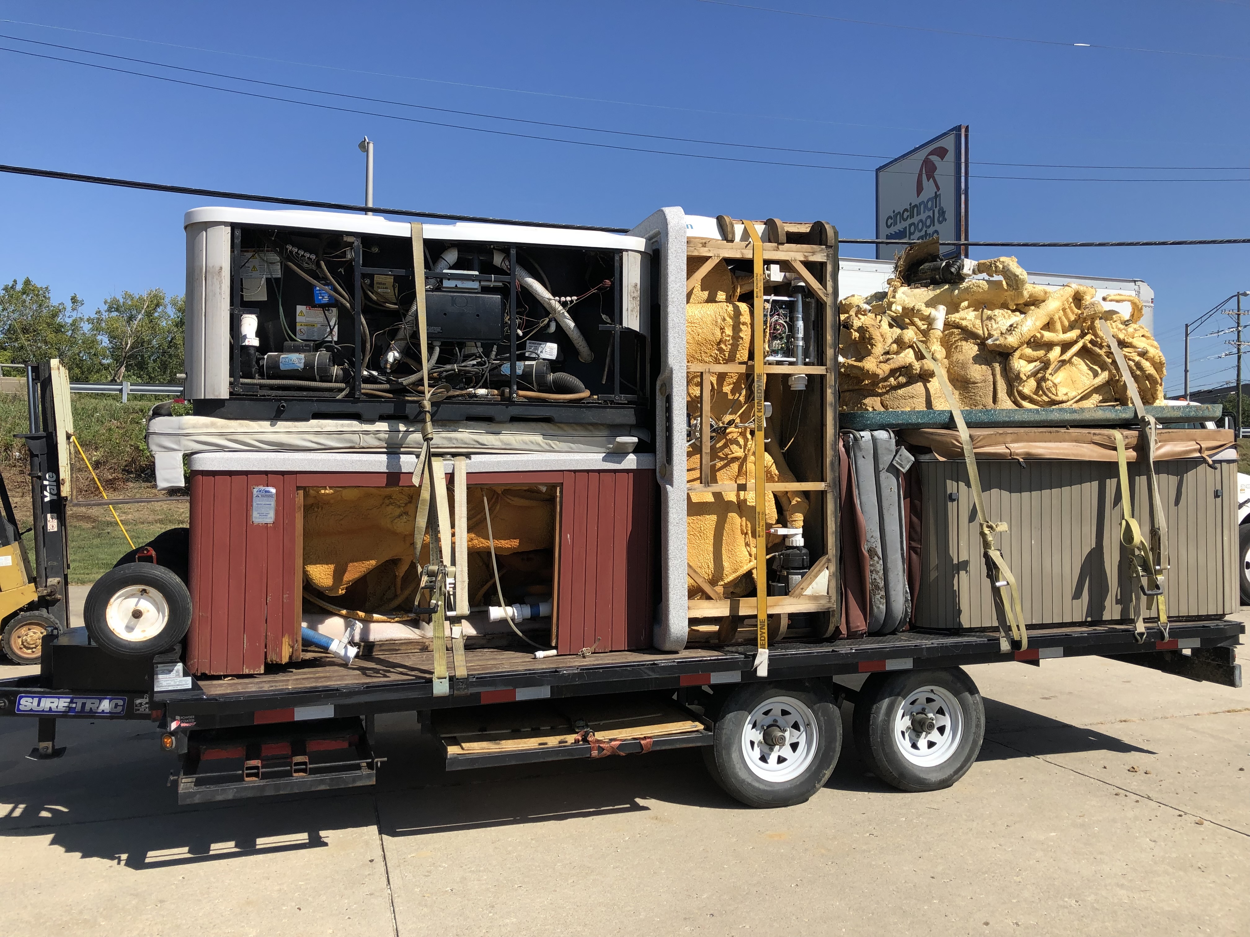 Flatbed trailer loaded with removed hot tub units